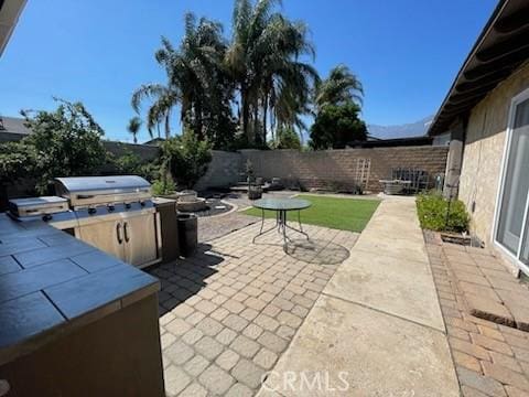 7430 Leucite Ave, Rancho Cucamonga, CA 91730 - fenced backyard featuring a patio area and an outdoor kitchen