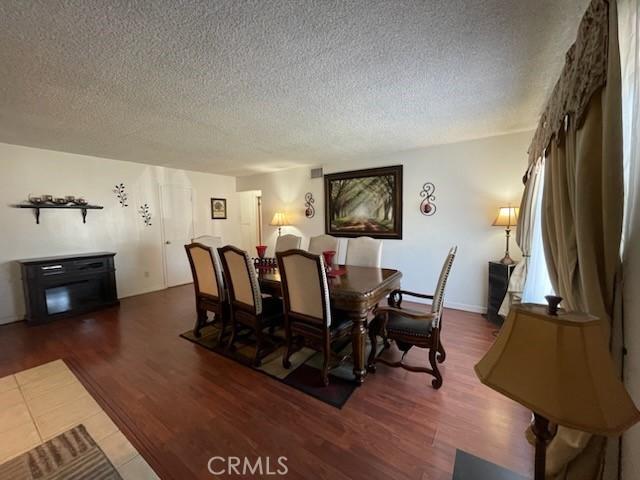 7430 Leucite Ave, Rancho Cucamonga, CA 91730 - dining area with a textured ceiling and wood finished floors