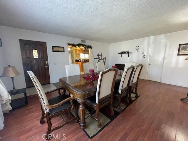 7430 Leucite Ave, Rancho Cucamonga, CA 91730 - dining room featuring a textured ceiling and wood finished floors