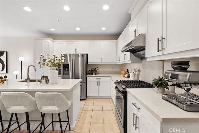 105 High Mdw, Lake Forest, CA 92610 - kitchen featuring black range with gas cooktop, under cabinet range hood, stainless steel fridge with ice dispenser, a kitchen bar, and white cabinetry