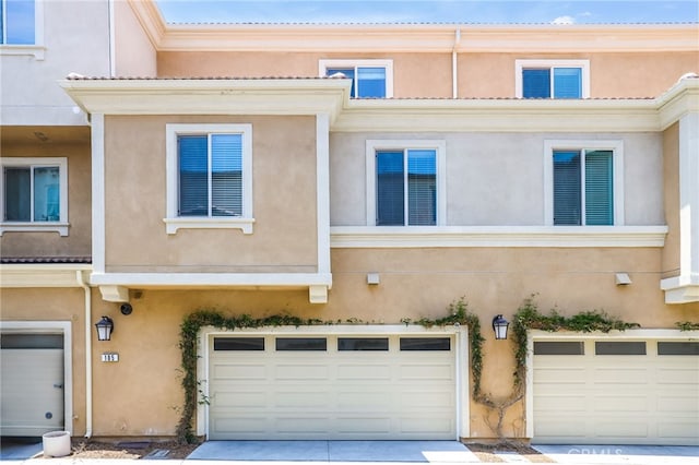 105 High Mdw, Lake Forest, CA 92610 - back of house with an attached garage, stucco siding, and concrete driveway