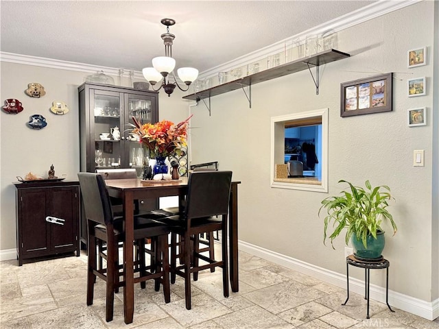 23821 Hillhurst Dr Unit 16, Laguna Niguel, CA 92677 - dining room featuring a chandelier, stone tile floors, and ornamental molding