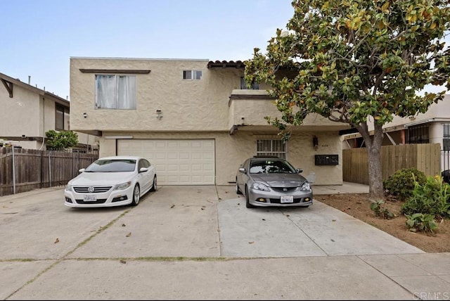 4139 46th St, San Diego, CA 92105 - view of front facade with concrete driveway, a garage, and stucco siding