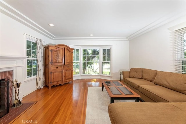 3766 Rose Ave, Long Beach, CA 90807 - living room featuring light wood-style floors, healthy amount of natural light, a brick fireplace, recessed lighting, and crown molding