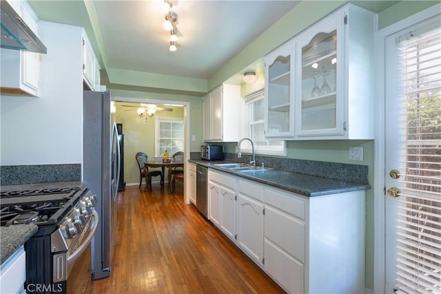 3766 Rose Ave, Long Beach, CA 90807 - kitchen with stainless steel appliances, under cabinet range hood, white cabinetry, and dark countertops