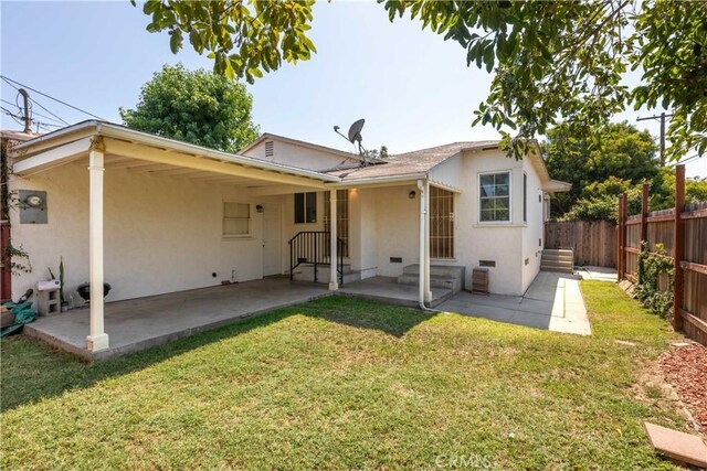 3766 Rose Ave, Long Beach, CA 90807 - rear view of property featuring a fenced backyard, stucco siding, and a patio area