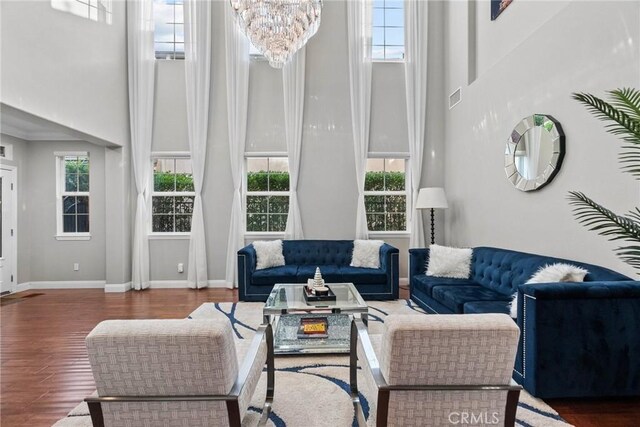 20704 Campania Ln, Porter Ranch, CA 91326 - living area with a towering ceiling, plenty of natural light, wood finished floors, and a chandelier