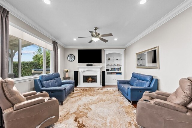 20704 Campania Ln, Porter Ranch, CA 91326 - living room featuring ornamental molding, built in shelves, recessed lighting, ceiling fan, and a glass covered fireplace