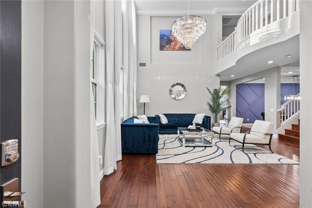 20704 Campania Ln, Porter Ranch, CA 91326 - living area with stairs, a chandelier, wood-type flooring, ornamental molding, and a towering ceiling