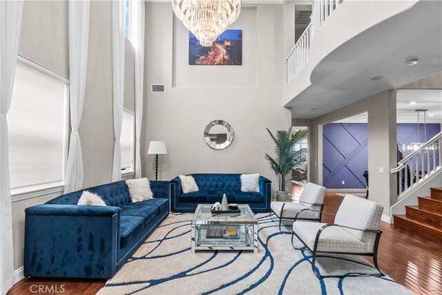 20704 Campania Ln, Porter Ranch, CA 91326 - living area featuring a chandelier, wood finished floors, stairway, and a high ceiling