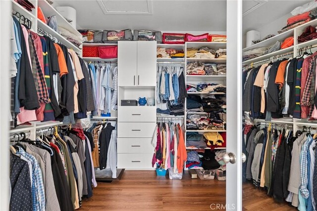 20704 Campania Ln, Porter Ranch, CA 91326 - walk in closet featuring attic access and wood finished floors