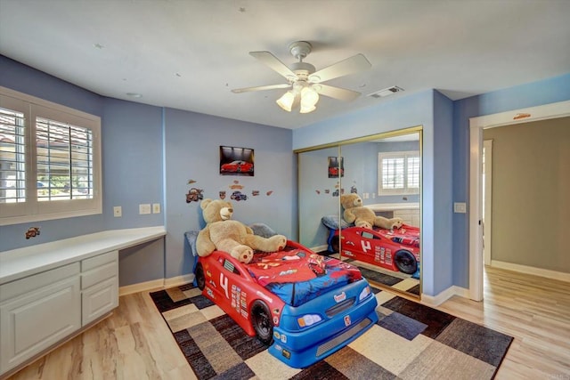 36485 Carney Rd, Valley Center, CA 92082 - bedroom with light wood-type flooring, built in study area, a closet, and a ceiling fan