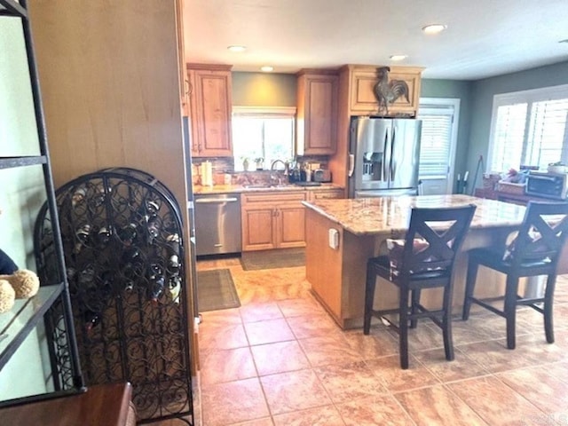 36485 Carney Rd, Valley Center, CA 92082 - kitchen featuring appliances with stainless steel finishes, a center island, a kitchen bar, plenty of natural light, and recessed lighting