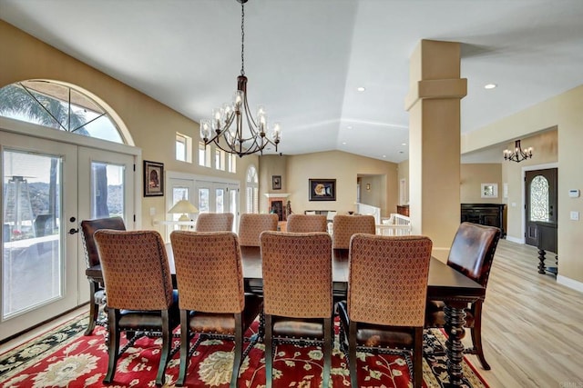 36485 Carney Rd, Valley Center, CA 92082 - dining area featuring a chandelier, french doors, light wood finished floors, vaulted ceiling, and a fireplace