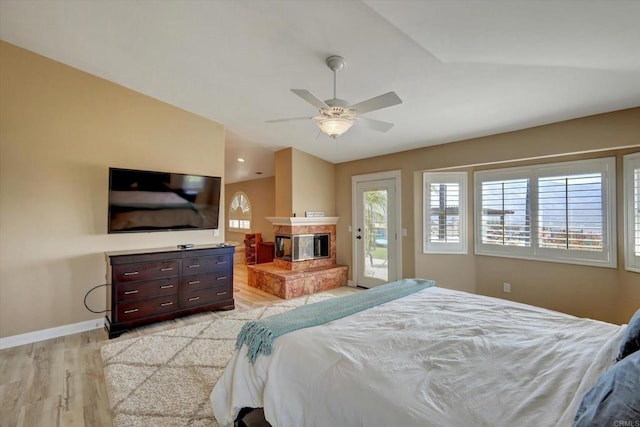 36485 Carney Rd, Valley Center, CA 92082 - bedroom featuring light wood-type flooring, access to outside, a multi sided fireplace, lofted ceiling, and a ceiling fan