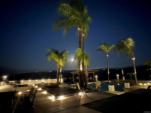 36485 Carney Rd, Valley Center, CA 92082 - pool at night featuring an outdoor pool and a patio area