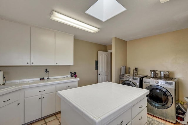 36485 Carney Rd, Valley Center, CA 92082 - laundry area featuring washing machine and clothes dryer, cabinet space, and a skylight