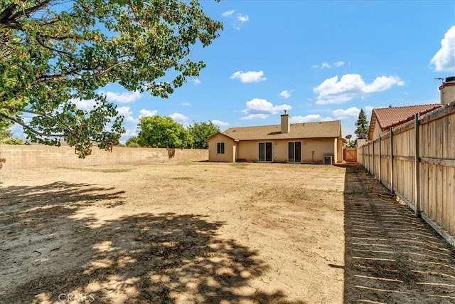 2508 Goldridge St, Selma, CA 93662 - back of property featuring a fenced backyard, a chimney, and stucco siding