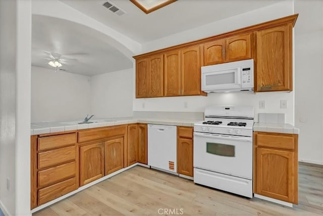 2508 Goldridge St, Selma, CA 93662 - kitchen featuring white appliances, light wood finished floors, ceiling fan, and tile countertops