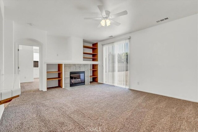 2508 Goldridge St, Selma, CA 93662 - unfurnished living room featuring light colored carpet, a ceiling fan, and a tiled fireplace