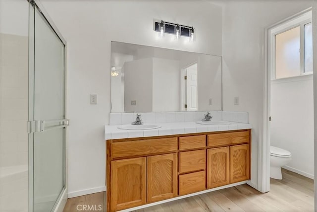 2508 Goldridge St, Selma, CA 93662 - bathroom with a shower stall, double vanity, and wood finished floors