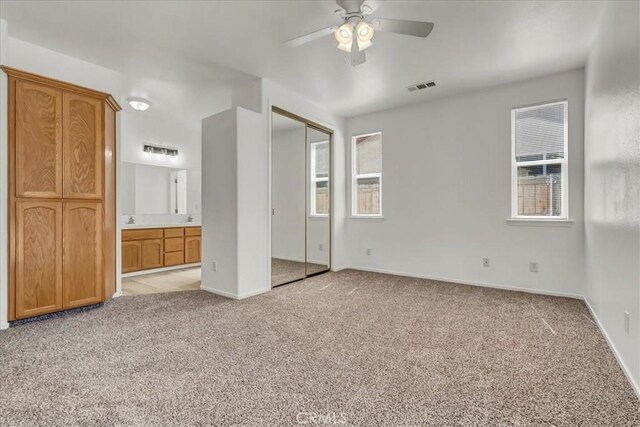 2508 Goldridge St, Selma, CA 93662 - unfurnished bedroom featuring light colored carpet, multiple windows, and connected bathroom