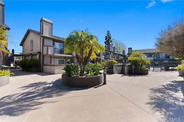 2175 Pacific Ave Unit E4, Costa Mesa, CA 92627 - view of front of house with stucco siding and a chimney