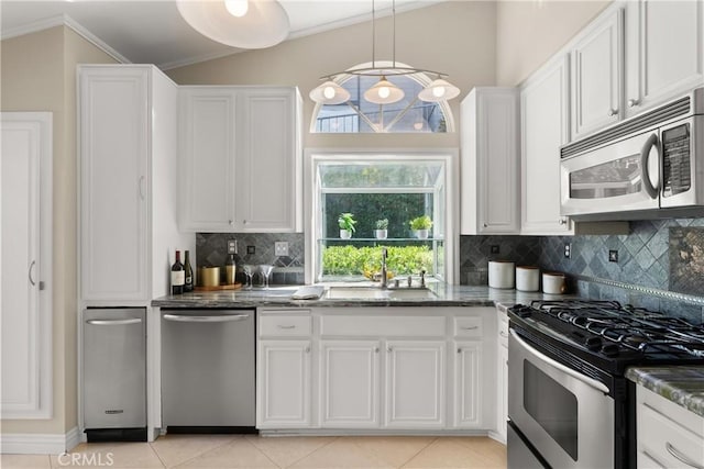 2175 Pacific Ave Unit E4, Costa Mesa, CA 92627 - kitchen with stainless steel appliances, white cabinets, decorative backsplash, crown molding, and dark stone countertops
