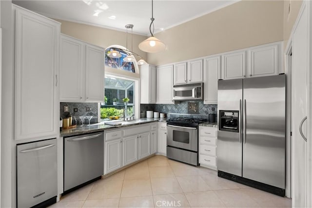 2175 Pacific Ave Unit E4, Costa Mesa, CA 92627 - kitchen featuring stainless steel appliances, tasteful backsplash, white cabinets, and a towering ceiling