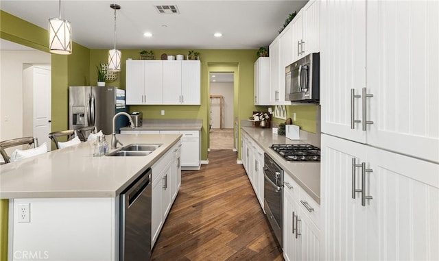 1568 Patterson Ranch Rd, Redlands, CA 92374 - kitchen with appliances with stainless steel finishes, dark wood-type flooring, recessed lighting, light countertops, and pendant lighting