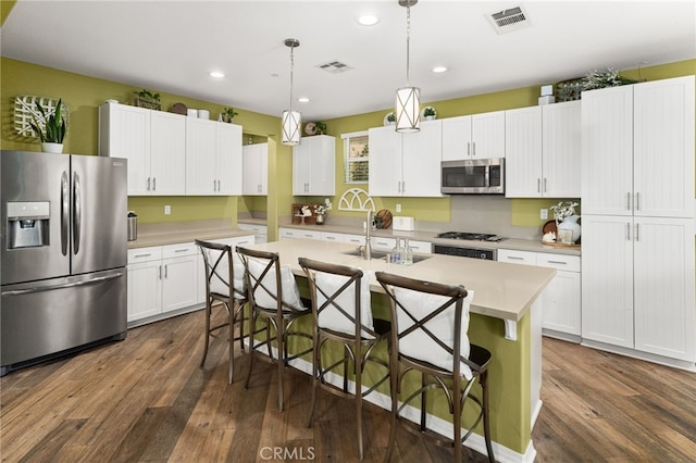 1568 Patterson Ranch Rd, Redlands, CA 92374 - kitchen featuring stainless steel appliances, dark wood-type flooring, light countertops, a kitchen breakfast bar, and recessed lighting