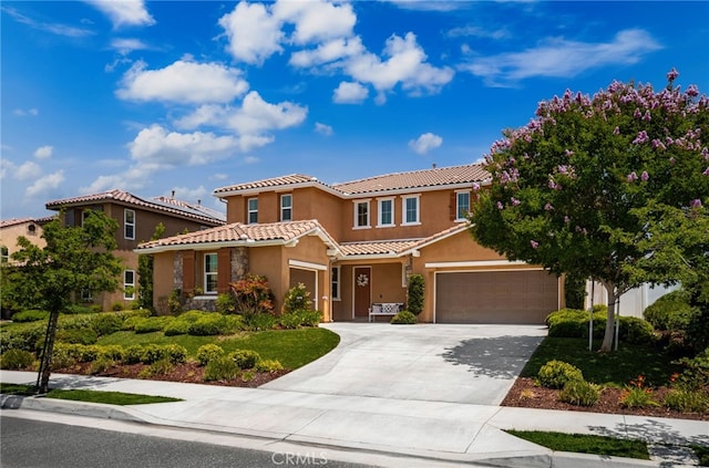 1568 Patterson Ranch Rd, Redlands, CA 92374 - mediterranean / spanish home featuring a tiled roof, stucco siding, driveway, and an attached garage