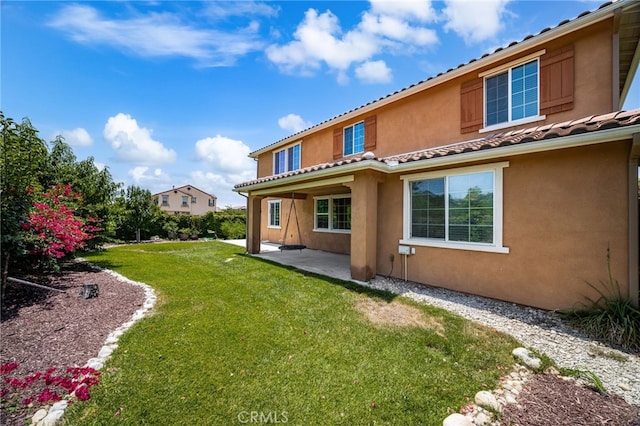 1568 Patterson Ranch Rd, Redlands, CA 92374 - rear view of property featuring a patio area, stucco siding, and a lawn