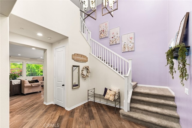 1568 Patterson Ranch Rd, Redlands, CA 92374 - staircase featuring wood finished floors, a chandelier, recessed lighting, and a high ceiling