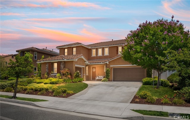 1568 Patterson Ranch Rd, Redlands, CA 92374 - mediterranean / spanish-style house featuring an attached garage, a tiled roof, concrete driveway, and stucco siding