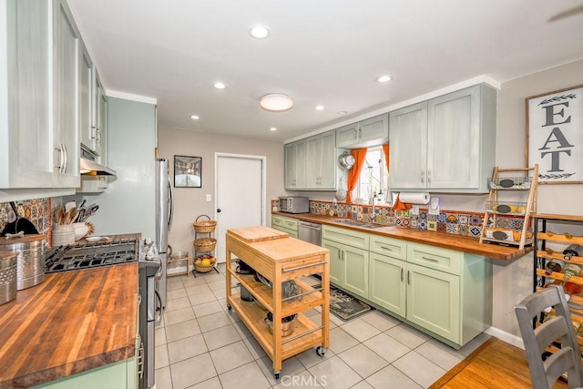 1134 N Rowan Ave, East Los Angeles, CA 90063 - kitchen featuring butcher block counters, green cabinets, stainless steel appliances, extractor fan, and recessed lighting