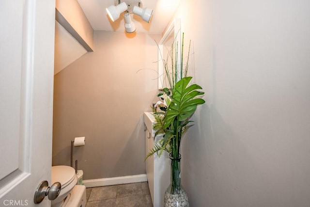 1134 N Rowan Ave, East Los Angeles, CA 90063 - half bathroom featuring toilet and baseboards
