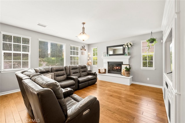 46287 Durango Dr, Temecula, CA 92592 - living area featuring light wood-style floors and a glass covered fireplace