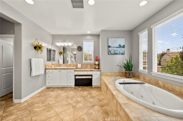 46287 Durango Dr, Temecula, CA 92592 - bathroom with vanity, a tub with jets, healthy amount of natural light, recessed lighting, and tile patterned floors
