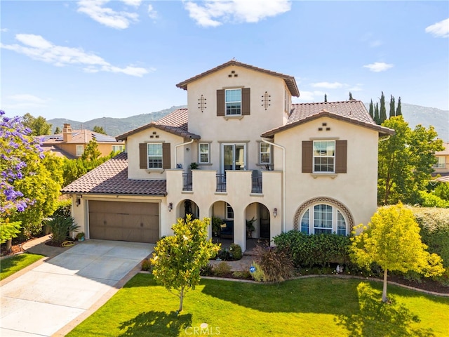 46287 Durango Dr, Temecula, CA 92592 - mediterranean / spanish house with a mountain view, a balcony, stucco siding, a tiled roof, and a front lawn