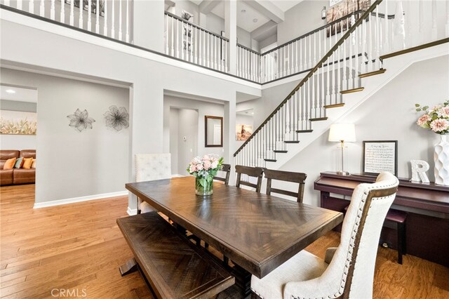 46287 Durango Dr, Temecula, CA 92592 - dining area with a towering ceiling, wood finished floors, stairs, and recessed lighting
