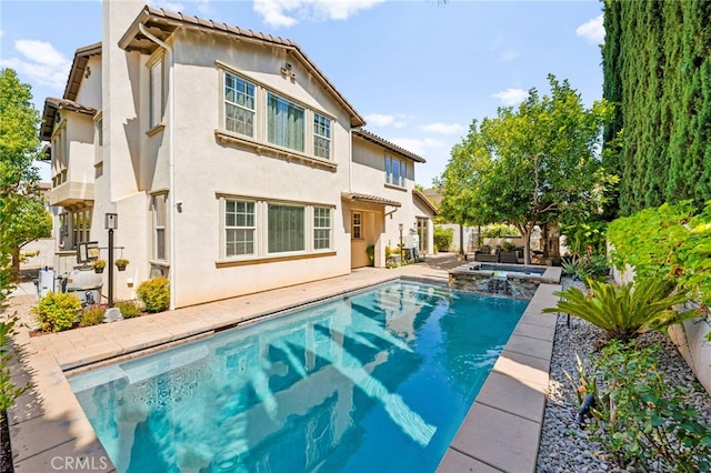 46287 Durango Dr, Temecula, CA 92592 - back of house featuring stucco siding, a pool with connected hot tub, and a patio area