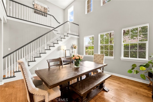 46287 Durango Dr, Temecula, CA 92592 - dining room with a high ceiling, hardwood / wood-style floors, and stairs