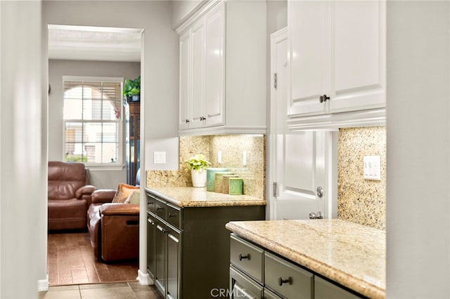 46287 Durango Dr, Temecula, CA 92592 - kitchen featuring white cabinetry, decorative backsplash, and light stone counters