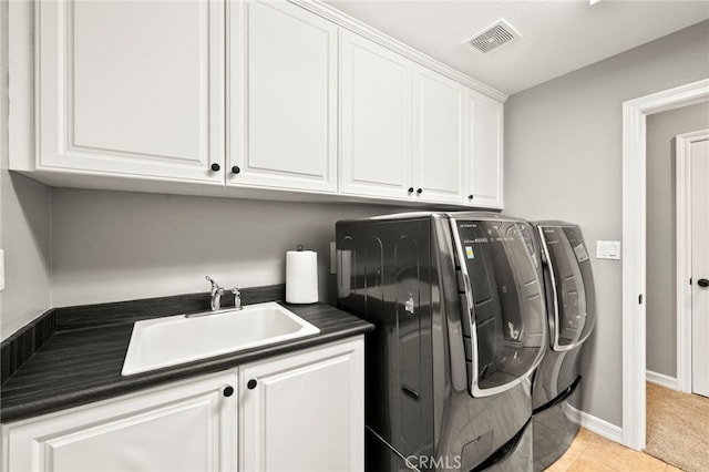 46287 Durango Dr, Temecula, CA 92592 - laundry room featuring washer and dryer, cabinet space, and light tile patterned flooring