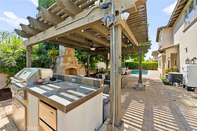 46287 Durango Dr, Temecula, CA 92592 - view of patio featuring ceiling fan, a pergola, an outdoor stone fireplace, and exterior kitchen