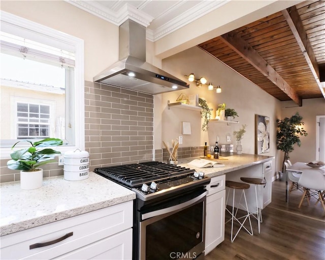 4917 W 140th St, Hawthorne, CA 90250 - kitchen featuring gas stove, island range hood, backsplash, crown molding, and white cabinetry