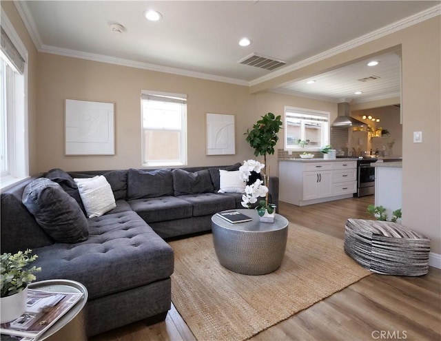 4917 W 140th St, Hawthorne, CA 90250 - living room with plenty of natural light, light wood-style floors, crown molding, and recessed lighting