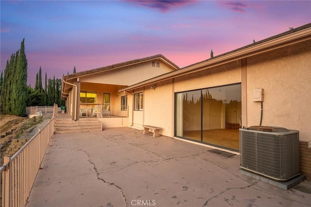 2591 Braided Mane Dr, Diamond Bar, CA 91765 - back of house at dusk featuring stucco siding, a garage, and a patio area