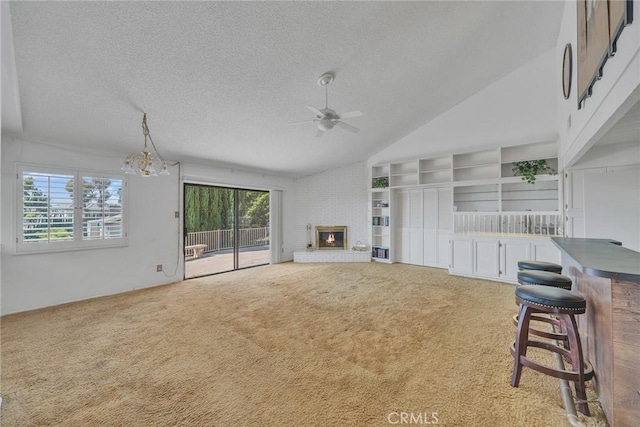 2591 Braided Mane Dr, Diamond Bar, CA 91765 - unfurnished living room featuring ceiling fan, carpet floors, a textured ceiling, a brick fireplace, and lofted ceiling